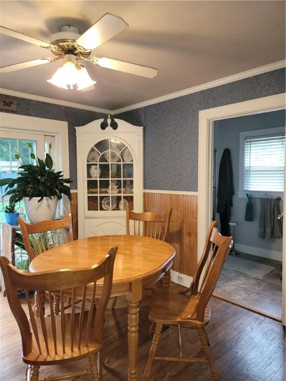 244 State Highway 320, Norwich, NY 13815 - dining space with wainscoting, wood finished floors, a ceiling fan, ornamental molding, and wood walls