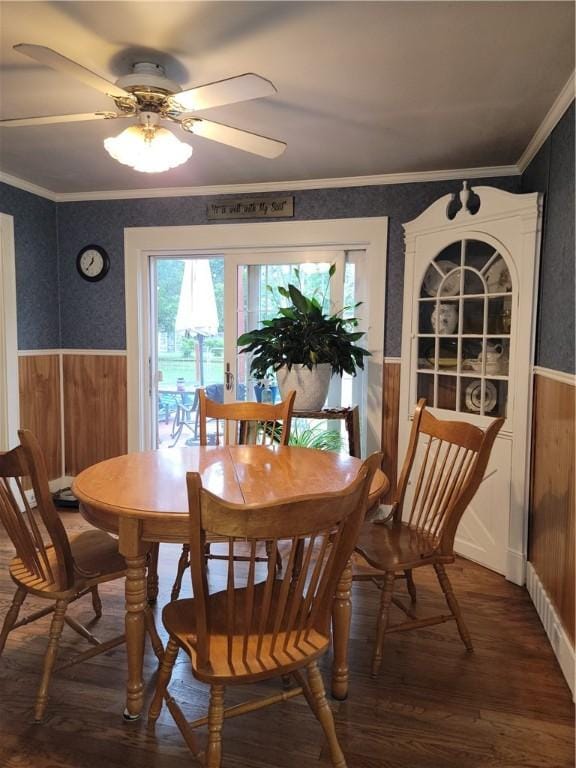 244 State Highway 320, Norwich, NY 13815 - dining space featuring a wainscoted wall, dark wood finished floors, ceiling fan, wood walls, and ornamental molding