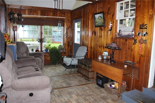 244 State Highway 320, Norwich, NY 13815 - living area featuring brick patterned flooring, wood walls, vaulted ceiling, and a chandelier