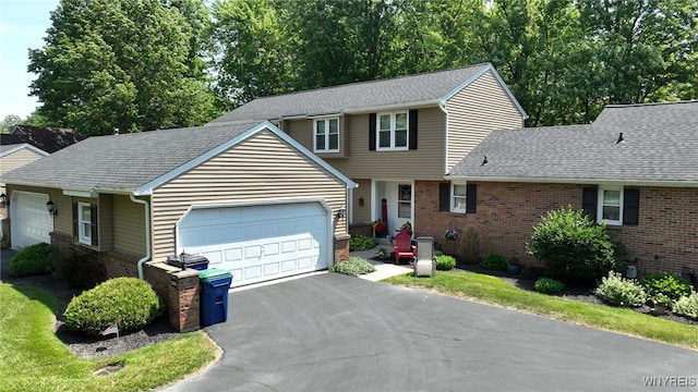 253 Old Oak Post Rd, Amherst, NY 14051 - view of front facade featuring a garage, asphalt driveway, brick siding, and a shingled roof