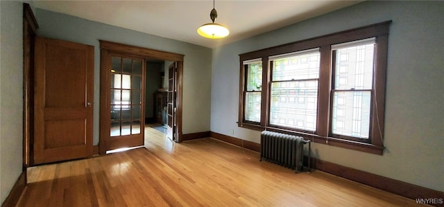 425 12th St, Niagara Falls, NY 14303 - spare room featuring radiator and light wood finished floors