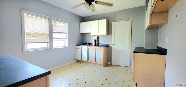 425 12th St, Niagara Falls, NY 14303 - kitchen with a ceiling fan, light flooring, white cabinets, and dark countertops