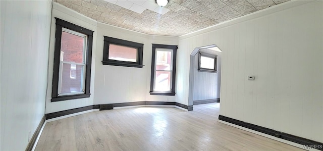 425 12th St, Niagara Falls, NY 14303 - unfurnished room with wood finished floors, ornamental molding, arched walkways, and an ornate ceiling