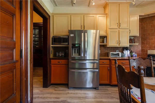 407 W Church St, Elmira City, NY 14901 - kitchen featuring stainless steel appliances, light wood-style flooring, dark countertops, track lighting, and backsplash