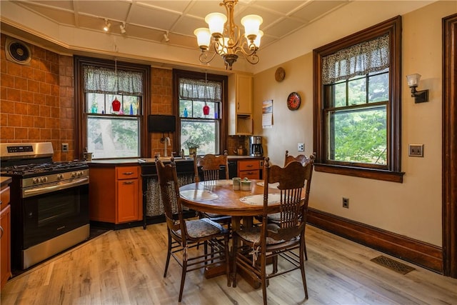 407 W Church St, Elmira City, NY 14901 - dining area featuring light wood-type flooring, a chandelier, and plenty of natural light