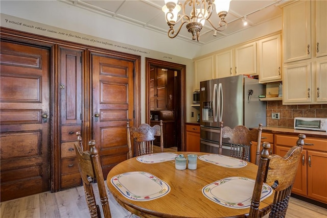407 W Church St, Elmira City, NY 14901 - dining room featuring a chandelier and light wood-style floors