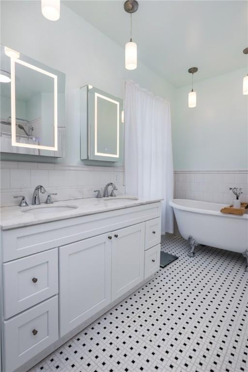 407 W Church St, Elmira City, NY 14901 - full bath featuring tile walls, double vanity, a soaking tub, tile patterned flooring, and a wainscoted wall