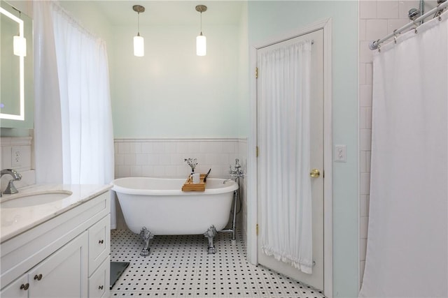 407 W Church St, Elmira City, NY 14901 - full bath featuring vanity, a soaking tub, wainscoting, tile walls, and tile patterned floors
