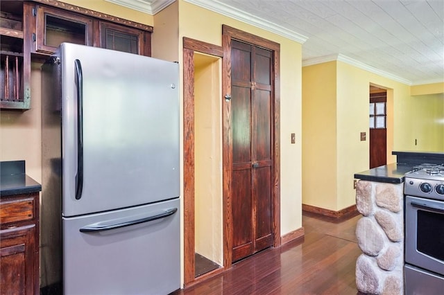 53 Alecia Dr, Greece, NY 14626 - kitchen with freestanding refrigerator, stainless steel gas range oven, dark wood finished floors, ornamental molding, and dark countertops