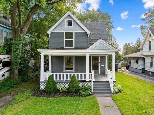 117 Prospect St, Lenox, NY 13032 - victorian home featuring covered porch, a front yard, and roof with shingles