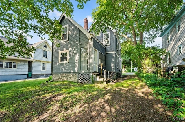 117 Prospect St, Lenox, NY 13032 - rear view of property with entry steps, a chimney, and a lawn