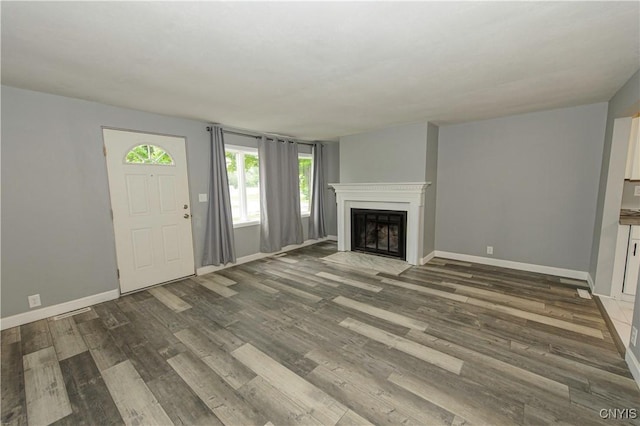 118 Hanover Ave, Salina, NY 13088 - unfurnished living room featuring a fireplace with flush hearth and wood finished floors