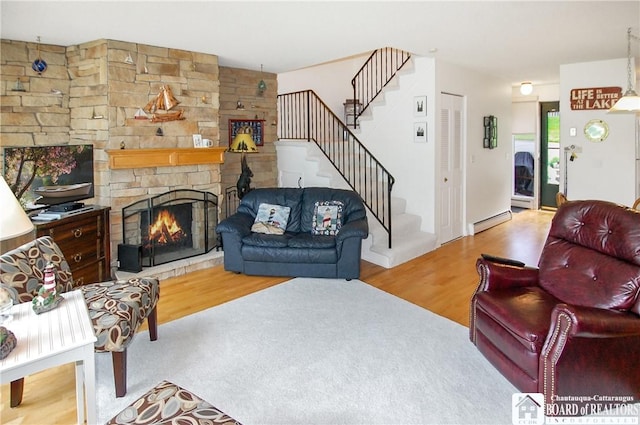 C4 Oneida Dr, Chautauqua, NY 14728 - living room featuring a baseboard heating unit, wood finished floors, stairway, and a fireplace