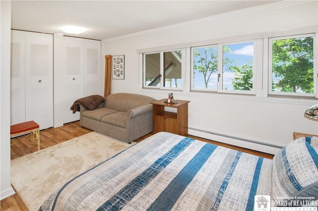 C4 Oneida Dr, Chautauqua, NY 14728 - bedroom featuring a baseboard heating unit, wood finished floors, multiple windows, and ornamental molding
