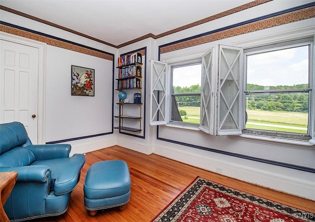 4790 E Lake Rd, Cazenovia, NY 13035 - sitting room featuring wood finished floors and ornamental molding