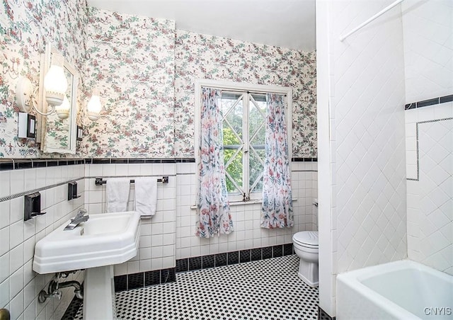 4790 E Lake Rd, Cazenovia, NY 13035 - full bathroom with wallpapered walls, wainscoting, and tile walls