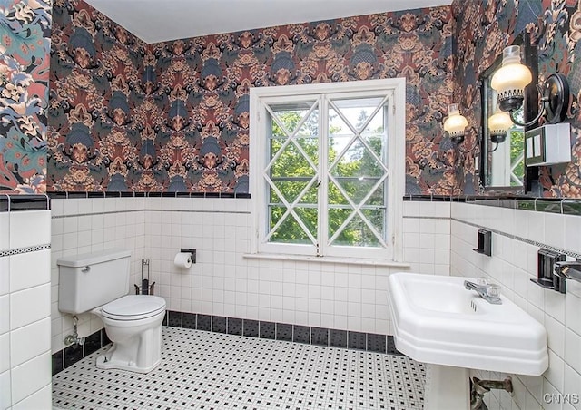4790 E Lake Rd, Cazenovia, NY 13035 - bathroom with plenty of natural light, tile walls, a wainscoted wall, and wallpapered walls