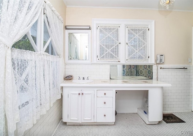 4790 E Lake Rd, Cazenovia, NY 13035 - bathroom with tile walls, tile patterned flooring, ornamental molding, a wainscoted wall, and vanity