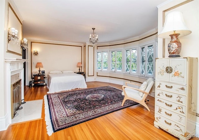 4790 E Lake Rd, Cazenovia, NY 13035 - bedroom featuring wood finished floors, a chandelier, a fireplace, and ornamental molding