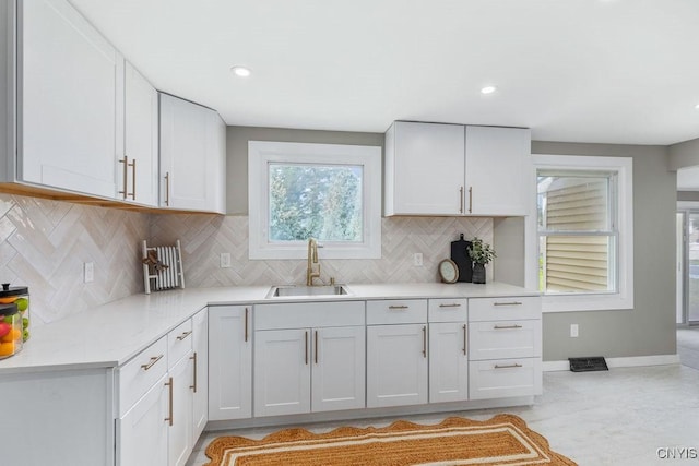 7921 Davis Rd N, Clay, NY 13041 - kitchen with light countertops, decorative backsplash, white cabinets, and recessed lighting