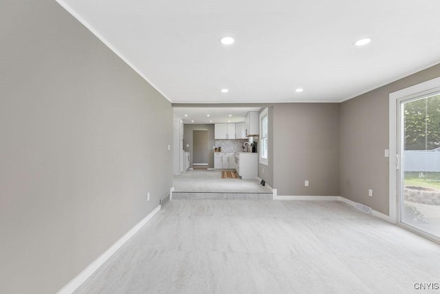 7921 Davis Rd N, Clay, NY 13041 - unfurnished living room featuring recessed lighting and crown molding