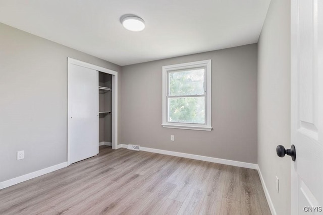 7921 Davis Rd N, Clay, NY 13041 - unfurnished bedroom featuring light wood finished floors and a closet