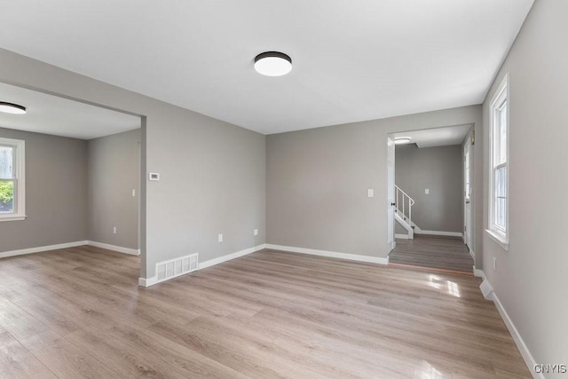 7921 Davis Rd N, Clay, NY 13041 - empty room featuring light wood finished floors and stairway