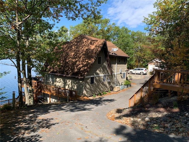 4555 Davies Rd, Hector, NY 14818 - view of home's exterior featuring stairs, asphalt driveway, and a deck