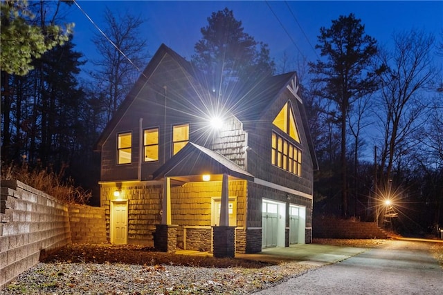4555 Davies Rd, Hector, NY 14818 - view of front of property with stone siding, an attached garage, concrete driveway, and a porch