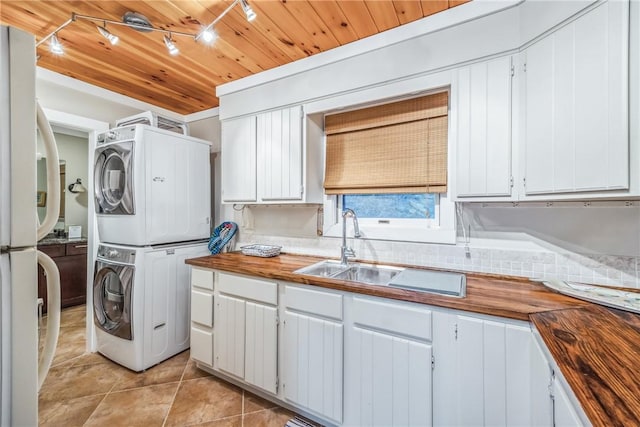 4555 Davies Rd, Hector, NY 14818 - laundry area with estacked washer and dryer, track lighting, light tile patterned floors, and wood ceiling