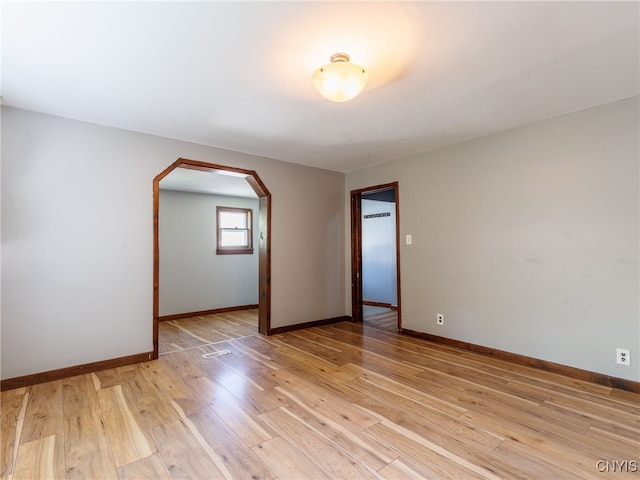 308 Howk St, Watertown City, NY 13601 - empty room featuring arched walkways and light wood-type flooring