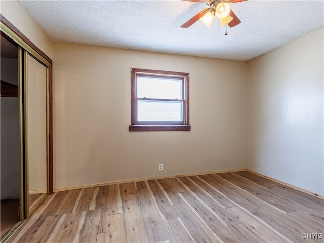 308 Howk St, Watertown City, NY 13601 - unfurnished bedroom featuring a closet, light wood-style floors, ceiling fan, and a textured ceiling
