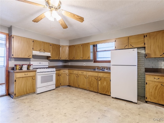 308 Howk St, Watertown City, NY 13601 - kitchen with white appliances, under cabinet range hood, light floors, a textured ceiling, and dark countertops