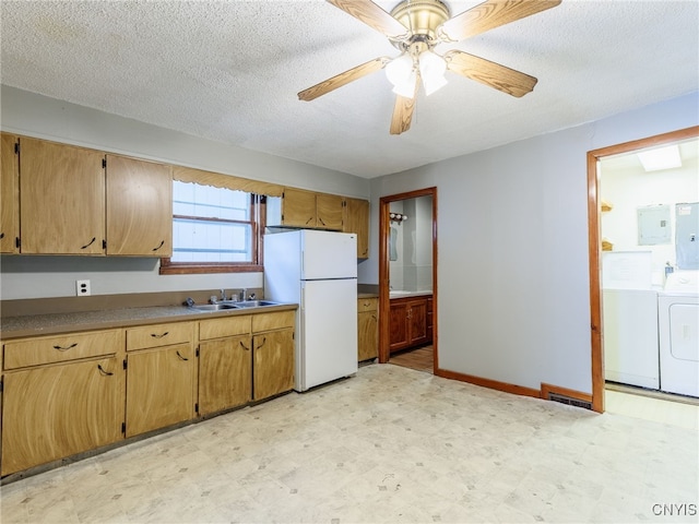 308 Howk St, Watertown City, NY 13601 - kitchen with freestanding refrigerator, light flooring, washing machine and dryer, electric panel, and a textured ceiling