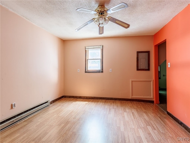 308 Howk St, Watertown City, NY 13601 - spare room featuring a baseboard radiator, light wood-style floors, ceiling fan, and a textured ceiling