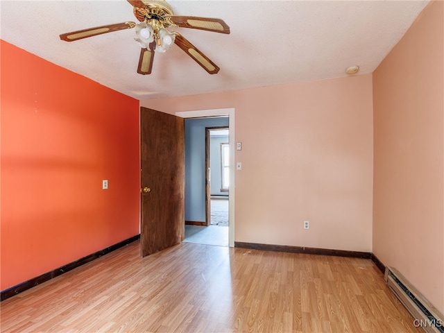 308 Howk St, Watertown City, NY 13601 - unfurnished room with a baseboard radiator, light wood-type flooring, and ceiling fan