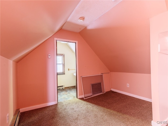 308 Howk St, Watertown City, NY 13601 - additional living space with a baseboard radiator, baseboard heating, carpet floors, and vaulted ceiling