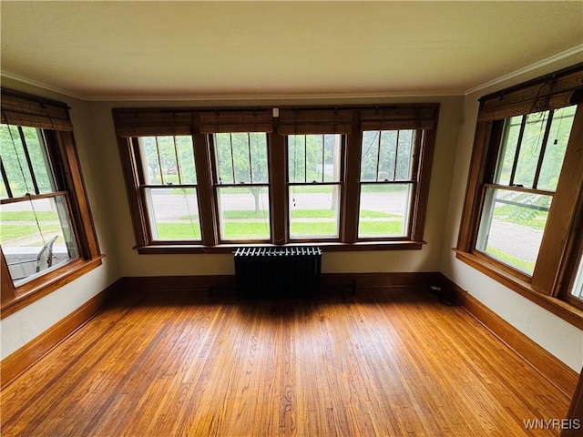 39 Chestnut St, Persia, NY 14070 - empty room featuring radiator heating unit, crown molding, and wood finished floors