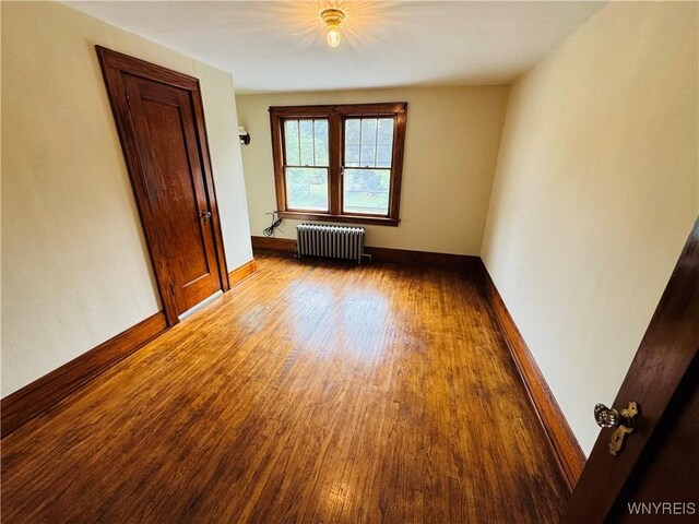 39 Chestnut St, Persia, NY 14070 - empty room featuring radiator heating unit and wood finished floors