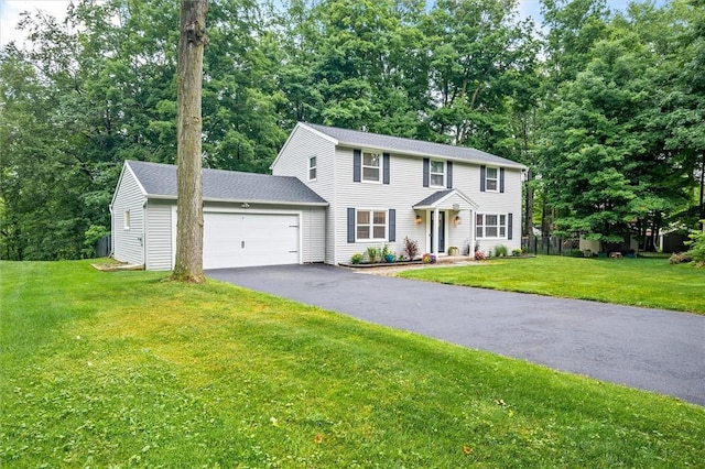 3389 Orchid Cres, Walworth, NY 14568 - colonial house featuring an attached garage, driveway, a front lawn, and view of wooded area