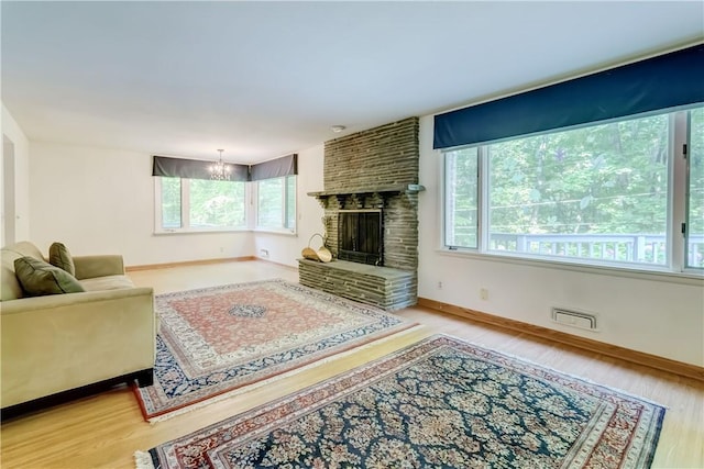 120 Scotch Ln, Irondequoit, NY 14617 - living room with healthy amount of natural light, wood finished floors, and a brick fireplace