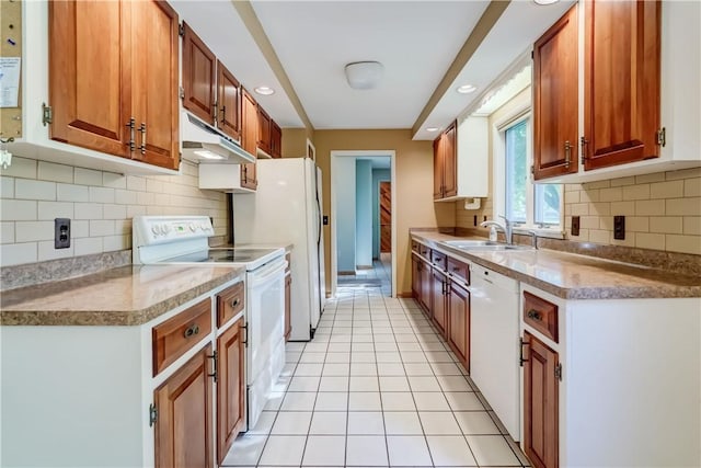 120 Scotch Ln, Irondequoit, NY 14617 - kitchen with white appliances, under cabinet range hood, tasteful backsplash, recessed lighting, and brown cabinetry