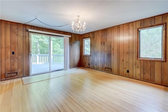 120 Scotch Ln, Irondequoit, NY 14617 - empty room featuring wood finished floors, a chandelier, and wood walls