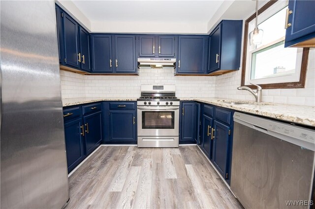 261 Ehinger Dr, West Seneca, NY 14224 - kitchen featuring stainless steel appliances, blue cabinets, under cabinet range hood, light wood-style floors, and light stone counters