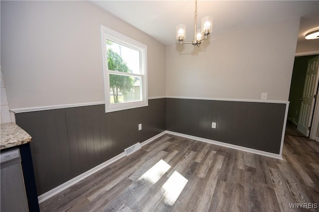 261 Ehinger Dr, West Seneca, NY 14224 - unfurnished dining area featuring wainscoting, wood finished floors, and a chandelier