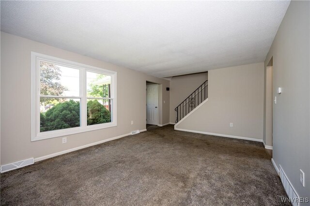 261 Ehinger Dr, West Seneca, NY 14224 - unfurnished living room featuring stairs and dark carpet