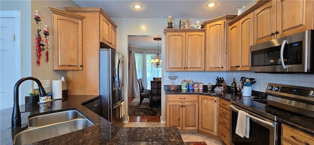3390 Conhocton Rd, Erwin, NY 14870 - kitchen featuring appliances with stainless steel finishes, light tile patterned floors, dark stone countertops, decorative backsplash, and recessed lighting