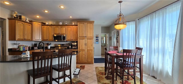 3390 Conhocton Rd, Erwin, NY 14870 - kitchen featuring appliances with stainless steel finishes, dark countertops, pendant lighting, a kitchen breakfast bar, and recessed lighting