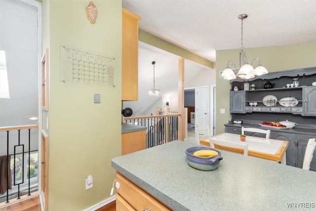 89 Rambling Rd, Amherst, NY 14051 - kitchen with a chandelier, lofted ceiling, and pendant lighting
