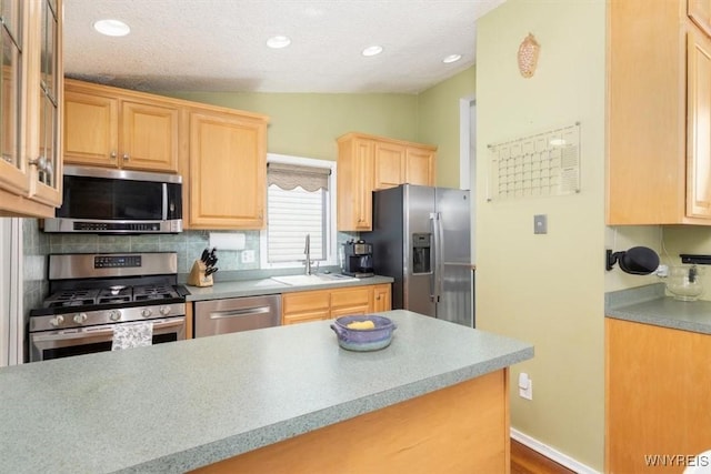 89 Rambling Rd, Amherst, NY 14051 - kitchen with appliances with stainless steel finishes, light brown cabinetry, vaulted ceiling, recessed lighting, and light countertops